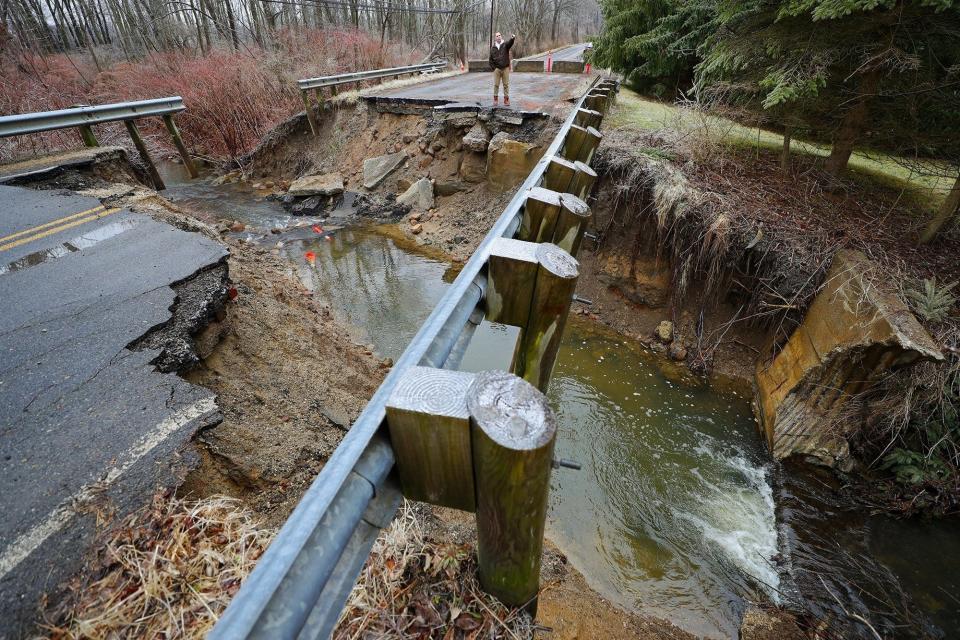 Norton resident Louis Ule looks out over ever-growing gorge that runs through Kungle Road in Norton on Feb. 6, 2020.