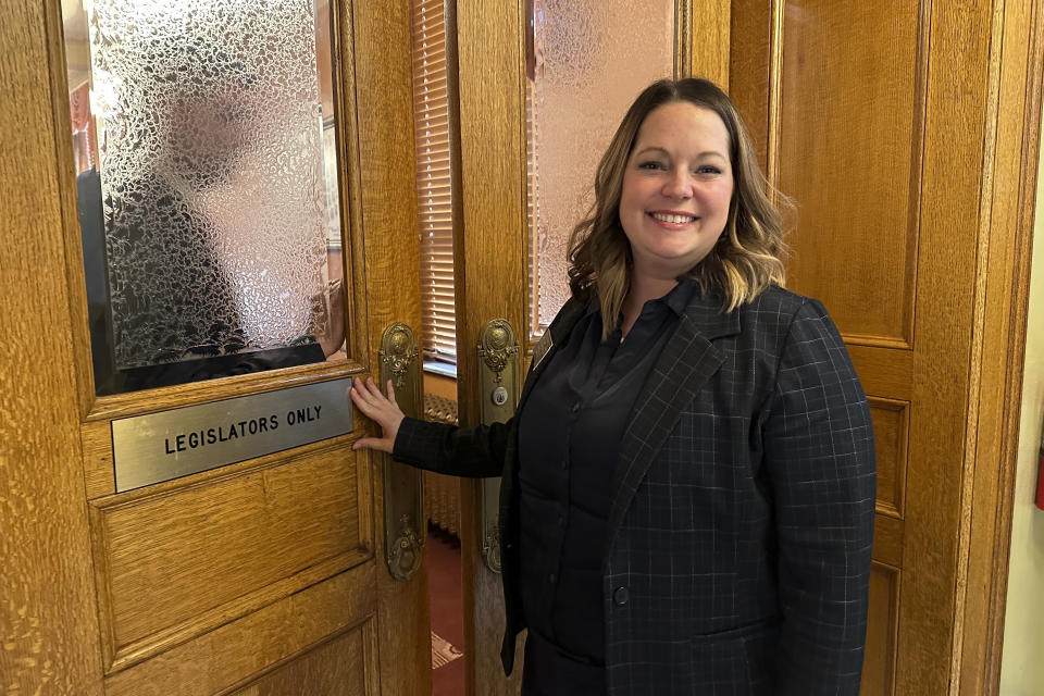 South Dakota Republican Rep. Taylor Rehfeldt pauses before entering the House of Representatives in the state Capitol in Pierre, S.D., on Wednesday, Feb. 21, 2024. She introduced a bill to require the state Department of Health to create an informational video about the state's abortion laws. AP Photo/Jack Dura)
