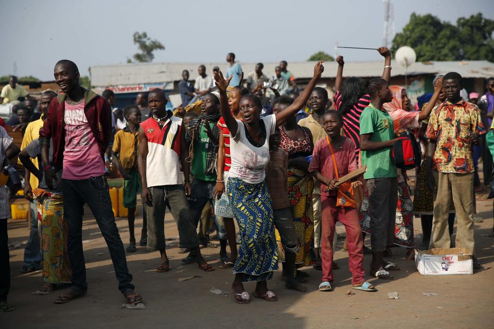 At PK12, the last checkpoint at the exit of the town, the Christian crowd cheers as thousands of Muslim residents from Bangui and Mbaiki flee the Central African Republic town of Bangui in a mass exodus using cars, pickups, trucks, lorries and motorcycles, escorted by Chadian troops on Friday, Feb. 7, 2014. Tit-for-tat violence killed more than 1,000 people in Bangui alone in a matter of days in December. An untold number have died in the weeks that followed, with most of the attacks in Bangui targeting Muslims. (AP Photo/Jerome Delay)