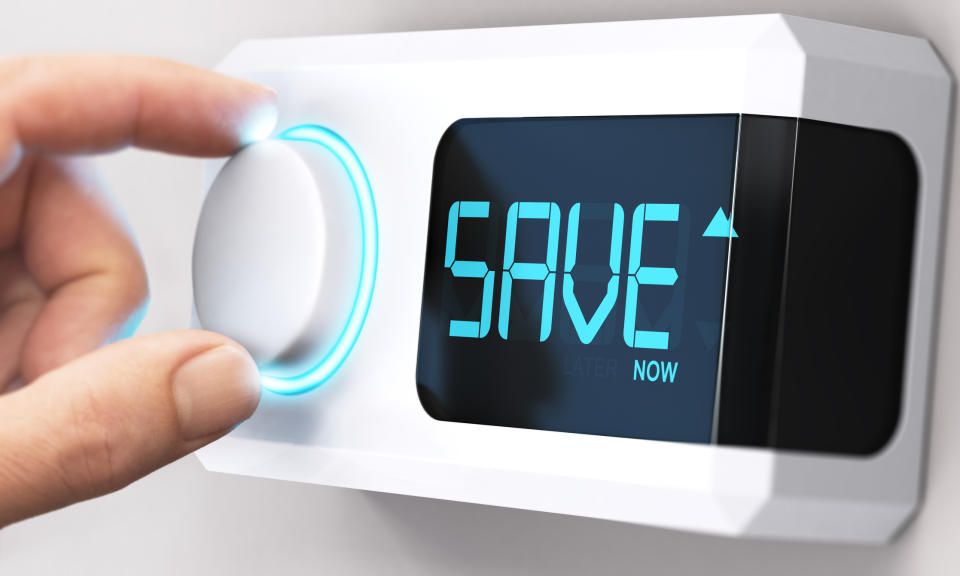 Hand turning a thermostat knob to increase savings by decreasing energy consumption. Source: Getty Images