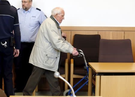 Defendant Siert Bruins, a 92-year-old former soldier of the Waffen-SS, Adolf Hitler's elite Nazi troop, arrives in a courtroom for the verdict of his trial in the western German city of Hagen, in this file picture taken January 8, 2014. REUTERS/Wolfgang Rattay/Files