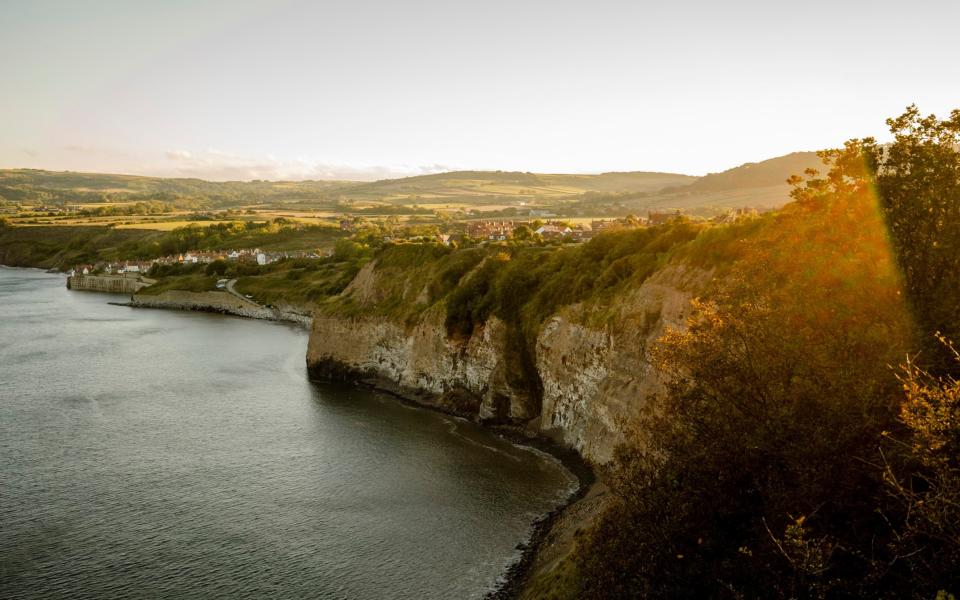 View of Robins Hood's Bay from a distance at sunset - Cavan Images/RFGetty Images