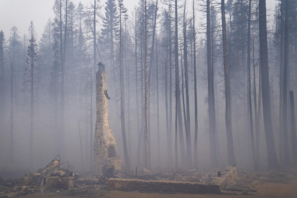 Smoke from the Cador Fire fills the air around a property destroyed in the fire in Twin Bridges, Calif., Thursday, Sept. 2, 2021. Better weather on Thursday helped the battle against a huge California forest fire threatening communities around Lake Tahoe, but commanders warned firefighters to keep their guard up against continuing dangers. (AP Photo/Jae C. Hong)