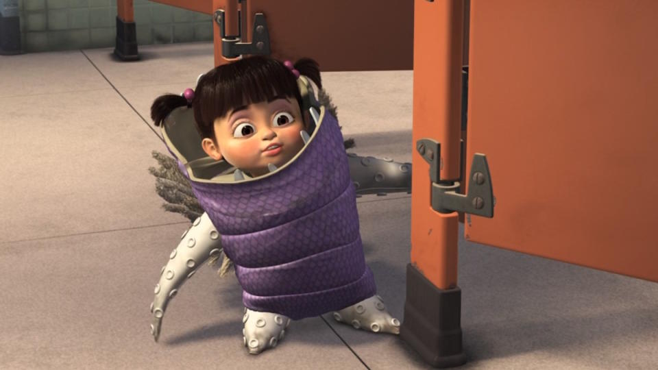 Boo scares Sully in a bathroom stall in Monsters Inc