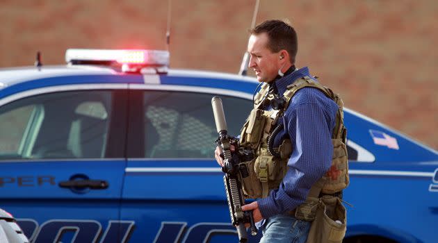 A Natrona County Sheriff's deputy in tactical gear leaves the scene. Photo: AAP