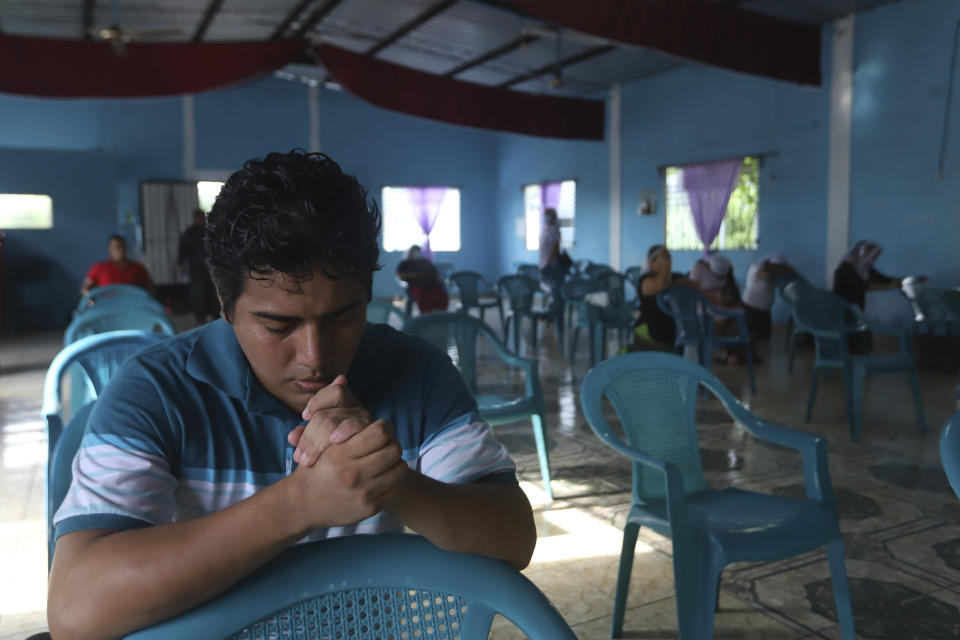 Nehemias Merino, a survivor of last year's landslide, participates in a day of prayers at the Siloe Church, in Los Angelitos, El Salvador, Sunday, Aug. 1, 2021. Merino and his mother survived the landslide that killed his brother Adolfo. (AP Photo/Salvador Melendez)