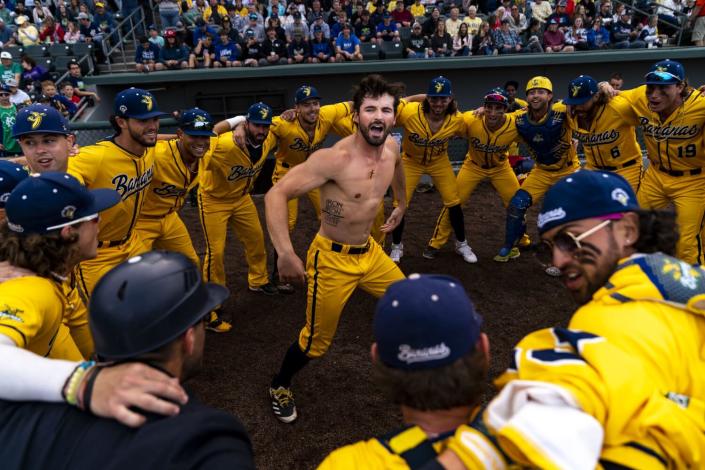 Savannah Bananas player Collin Ledbetter pumps up his teammates during a pregame dance.