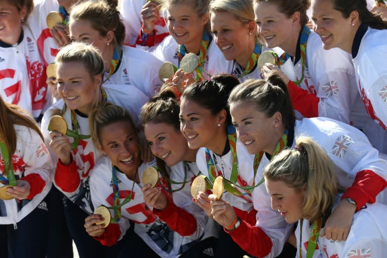 Members of the the British Olympic Team pose with their medals at London's Heathrow airport after arriving back from Rio on August 23, 2016