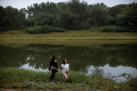 Chinese performance artist Han Bing poses with Patricia Calvo for German photographer Katharina Hesse during a shoot at the outskirts of Beijing, China, October 2, 2017. REUTERS/Thomas Peter