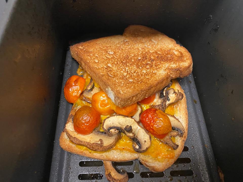 pesto, sliced cherry tomatoes, and mushrooms on bread  in an air fryer