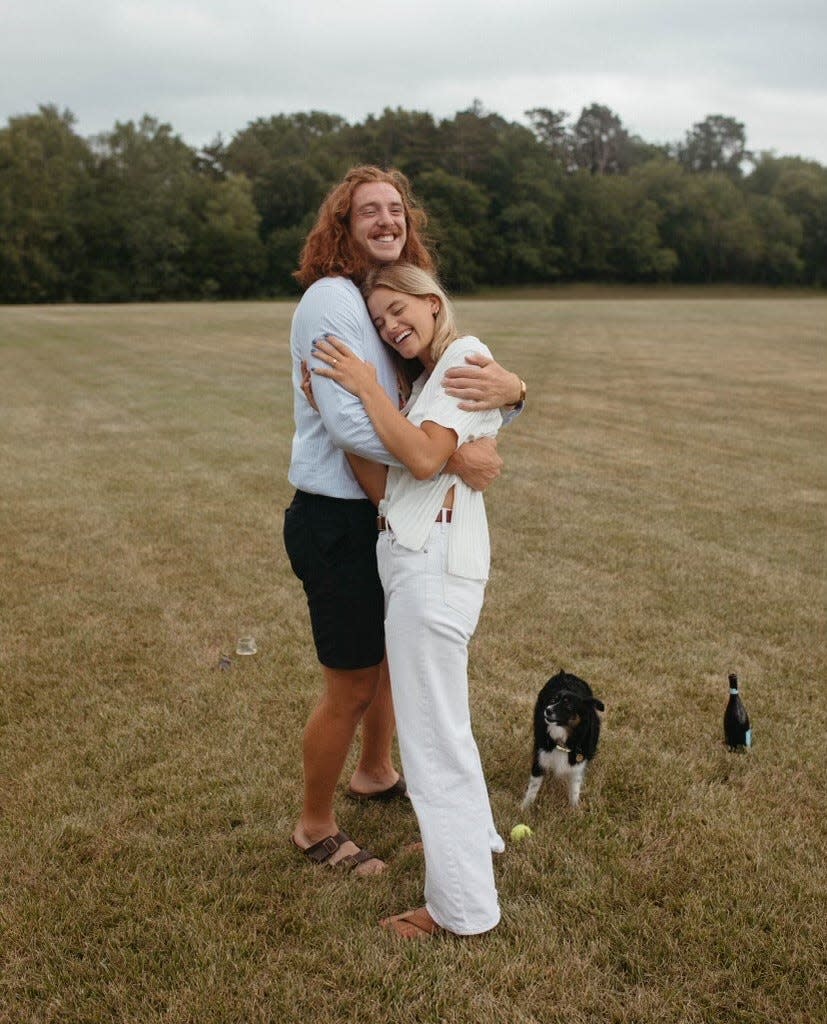 Former Iowa State football player Chase Allen and Emma Dau embrace after his successful marriage proposal