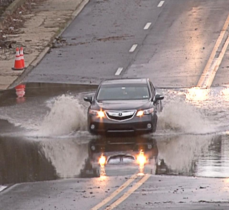 A motorist drives through high water on Philadelphia Pike on Wednesday January 10, 2024. A storm the previous day soaked much of the state and caused area flooding.