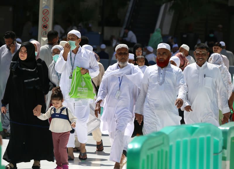 Muslim pilgrims wear protective face masks to prevent contracting coronavirus, as they arrive at the Grand mosque in the holy city of Mecca