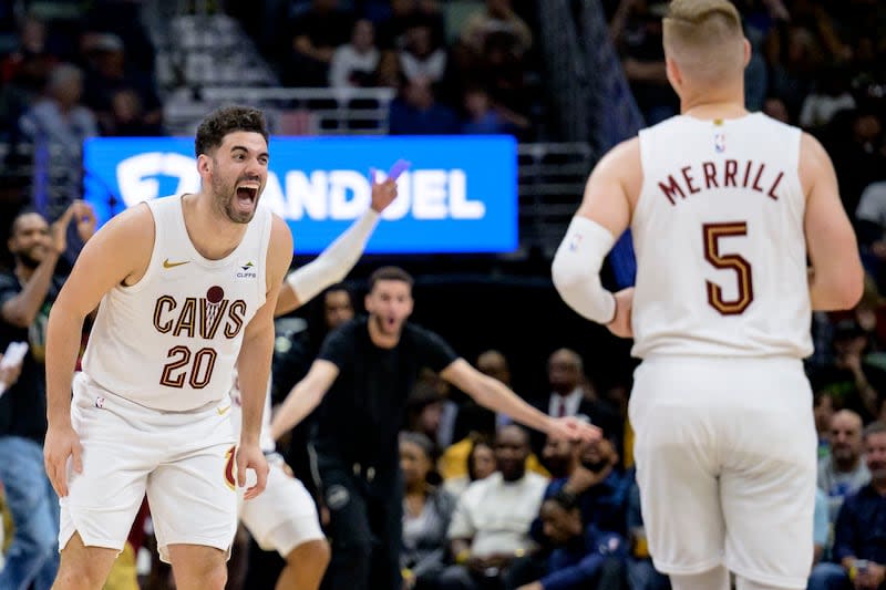 Cleveland Cavaliers forward Georges Niang (20) cheers for guard Sam Merrill (5) during game against the New Orleans Pelicans in New Orleans, Wednesday, March 13, 2024. | Matthew Hinton, Associated Press