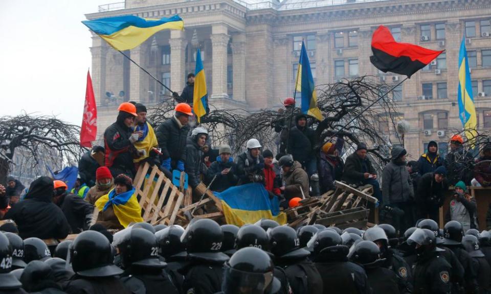 Ukrainian pro-EU activists wave flags in Independence Square in Kyiv, 11 December 2013.