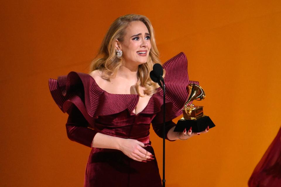 Adele accepts the award for best pop solo performance for “Easy On Me”.