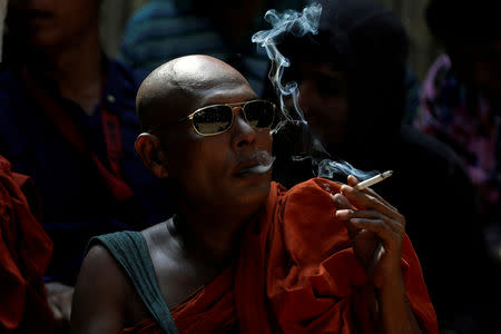 A Buddhist monk waits for the final verdict for Muslim lawyer Ko Ni's murder case at Insein court in Yangon, Myanmar, February 15, 2019. REUTERS/Ann Wang