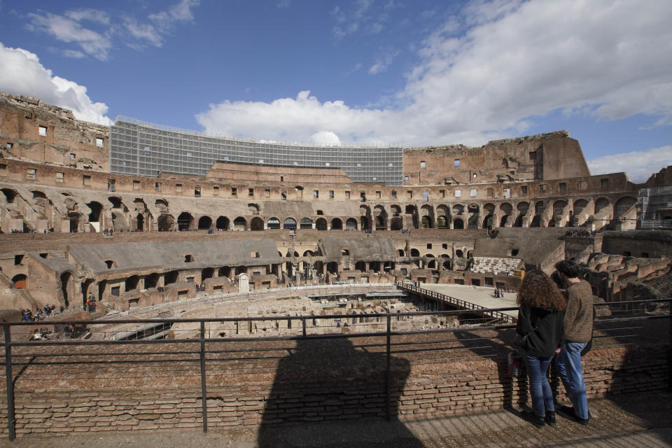 Tourists visit the Colosseum, in Rome, Saturday, March 7, 2020. With the coronavirus emergency deepening in Europe, Italy, a focal point in the contagion, risks falling back into recession as foreign tourists are spooked from visiting its cultural treasures and the global market shrinks for prized artisanal products, from fashion to design. (AP Photo/Andrew Medichini)