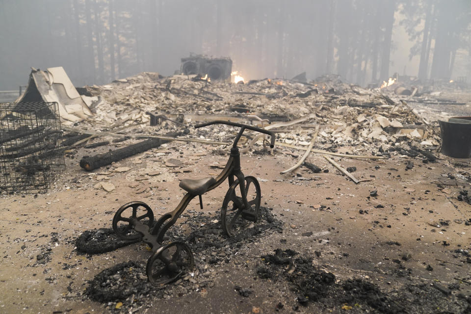 A charred tricycle was about all that was left standing Thursday inside a burnt-to-the-ground home in Bonny Doon, California. Half of California&rsquo;s 20 most-destructive wildfires have occurred within the last 10 years. (Photo: ASSOCIATED PRESS)