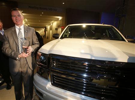 Jeff Luke, GM Chief Engineer of full and mid-size trucks, poses next to a Silverado pickup truck after it won the Truck of the Year award during the press preview day of the North American International Auto Show in Detroit, Michigan January 13, 2014. REUTERS/Rebecca Cook