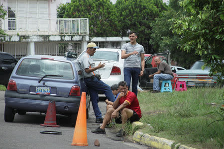 People wait outside their vehicles in an attempt to refuel at a gas station of the state oil company PDVSA in San Cristobal, Venezuela, May 17, 2019. REUTERS/Carlos Eduardo Ramirez