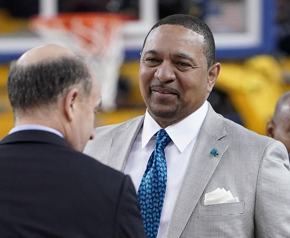 FILE - NBA analyst Mark Jackson, right, talks with Jeff Van Gundy, left, and others before Game 4 of basketball's NBA Finals between the Golden State Warriors and the Toronto Raptors in Oakland, Calif., June 7, 2019. Add Jackson to the long list of ESPN reporters and commentators who have been laid off over the past five weeks. Jackson was let go on Monday, July 31, 2023, with two years remaining on his contract. (AP Photo/Tony Avelar, File)