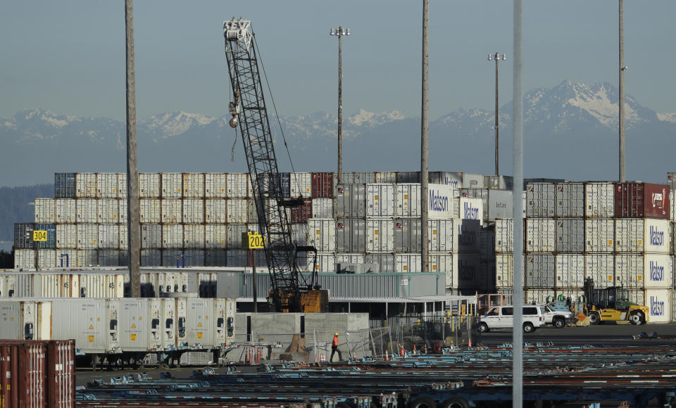 A worker walks near truck trailers and cargo containers, Friday, May 10, 2019, at the Port of Tacoma in Tacoma, Wash. U.S. and Chinese negotiators resumed trade talks Friday under increasing pressure after President Donald Trump raised tariffs on $200 billion in Chinese goods and Beijing promised to retaliate. (AP Photo/Ted S. Warren)