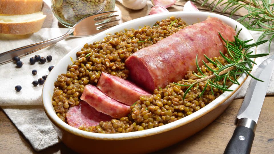 Cotechino con lenticchie is the yummy Italian pairing of sausage and lentils. - barbajones/Shutterstock