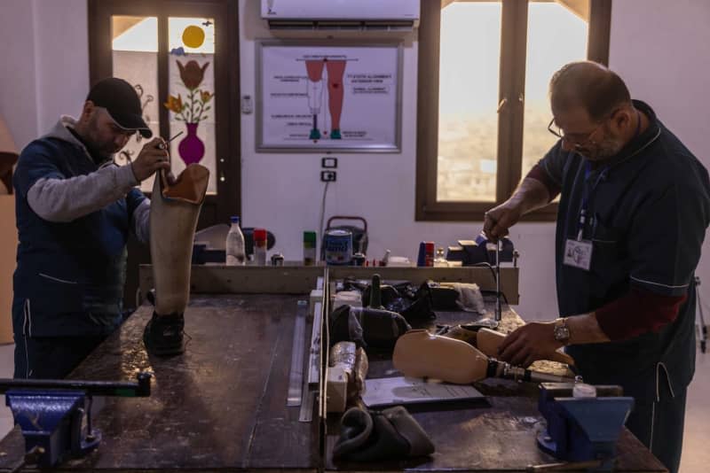 Medical technicians prepare prosthetic limbs for amputees at Aqrabat Specialized Hospital in Idlib Governorate for who those got injured in the 7.8-magnitude earthquake that struck southern Turkey and northern Syria on 06 February 2023. Anas Alkharboutli/dpa