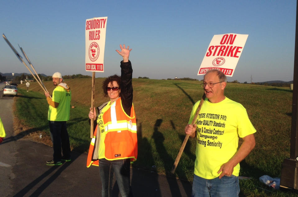 Workers hold picket signs outside the Jim Beam plant in Clermont, Ky., on Saturday, Oct. 15, 2016.