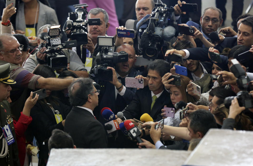 Colombia's President Gustavo Petro, left, back to camera, talks with the press during the South American Summit at Itamaraty palace in Brasilia, Brazil, Tuesday, May 30, 2023. South America's leaders are gathering as part of President Luiz Inácio Lula da Silva's attempt to reinvigorate regional integration efforts. (AP Photo/Gustavo Moreno)