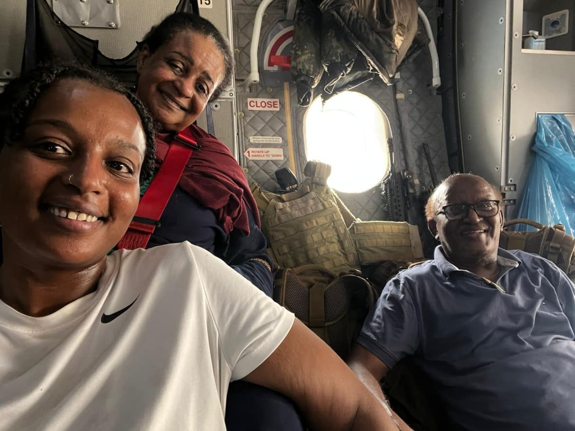 Dalia Abbadi, left, is pictured with her parents on an emergency evacuation flight out of Sudan. (Submitted by Dalia Abbadi - image credit)