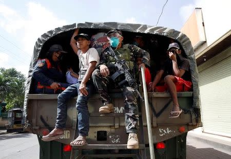 Soldiers and residents board a military truck, as they prepare to depart to an evacuation center, after the Mayon volcano erupted in Guniobatan, Albay Province, Philippines January 23, 2018. REUTERS/Stringer