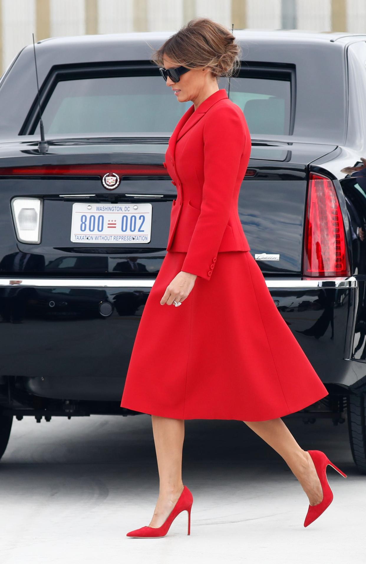 Melania Trump wears a red Dior skirt suit after arriving with President Donald Trump on Air Force One at Orly Airport, south of Paris, on July 13, 2017.