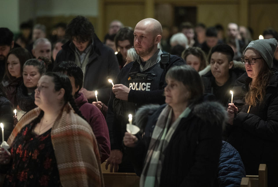 Community members gather and hold a vigil for the six people killed in a plane crash, in Fort Smith, Northwest Territories, on Wednesday, Jan. 24, 2024. (Jason Franson/The Canadian Press via AP)