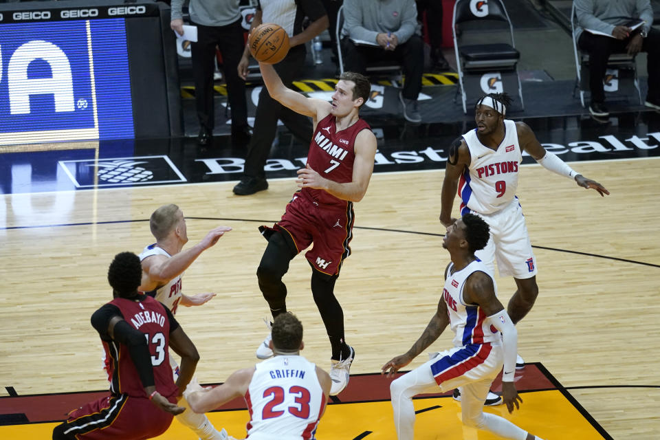 Miami Heat guard Goran Dragic (7) shoots over Detroit Pistons center Mason Plumlee, left, forward Blake Griffin (23) and forward Jerami Grant (9) during the second half of an NBA basketball game, Saturday, Jan. 16, 2021, in Miami. (AP Photo/Lynne Sladky)