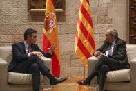 Spanish Prime Minister Pedro Sanchez, left, talks with Catalan regional President Quim Torra at the Palace of the Generalitat, the headquarter of the Government of Catalonia, in Barcelona, Thursday, Feb. 6, 2020. (AP Photo/Emilio Morenatti)