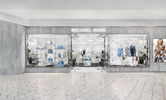 Michael Kors storefront with gray walls, white tile floor, and off-white ceiling.