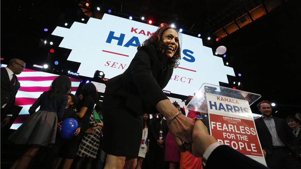 Kamala Harris shakes hands with a supporter.