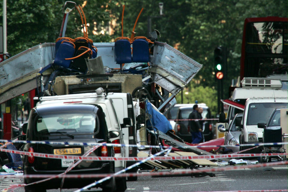 FILE -- The wreckage of a double-decker bus with its top blown off and damaged cars scattered on the road at Tavistock Square in central London in this July 7, 2005 file photo. Britain has planned for a dizzying array of security nightmares surrounding the Olympics, including a coordinated attack like the London transit bombings, a dirty bomb or a cyberattack. In the wake of France's deadly shootings, one scenario weighing heavily on the minds of security officials is the self-starter operating with little or no help from others. British suicide bombers killed 52 people during rush-hour attacks on July 7, 2005, MI5 and police counterterrorism units have vastly boosted their intelligence network. The country's surveillance agency, known as GCHQ, has the capability to listen in on people's telephone conversations and monitor their online communications. Surveillance units have also been attached to troops serving in places such as Afghanistan, specifically to gather intelligence that may lead back to Britain. (AP Photo/Sang Tan, File)