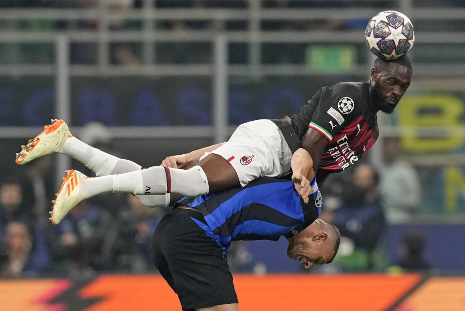 Inter Milan's Edin Dzeko is challenged by AC Milan's Fikayo Tomori, top, during the Champions League semifinal second leg soccer match between Inter Milan and AC Milan at the San Siro stadium in Milan, Italy, Tuesday, May 16, 2023. (AP Photo/Antonio Calanni)