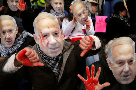 FILE PHOTO: Anti-Israel demonstrators led by the protest group Code Pink wear masks of Israeli Prime Benjamin Netanyahu as they sit at the entrance to the American Israel Public Affairs Committee (AIPAC) policy conference at the Washington Convention Center in Washington, March 1, 2015. REUTERS/Jonathan Ernst/File Photo