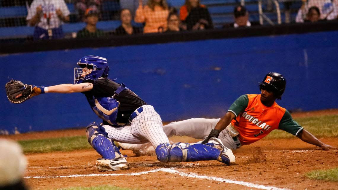 Frederick Douglass’ Jeremiah Lowe (3) slides home ahead of the tag of Henry Clay catcher Mason Draper in the Broncos’ 5-0 win at Henry Clay on Wednesday.