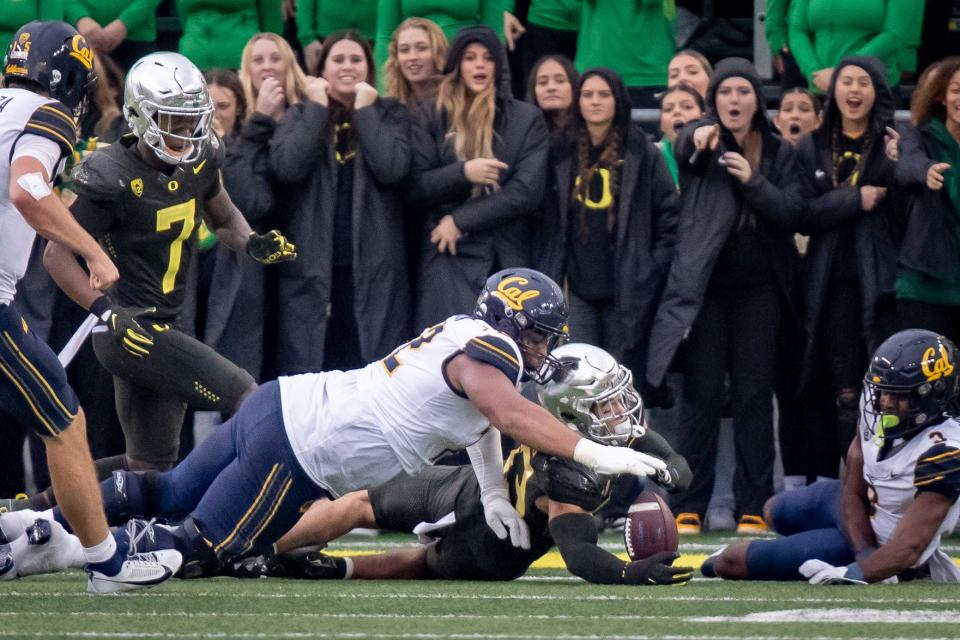 Oregon defensive back Evan Williams recovers a fumble as the No. 6 Oregon Ducks host California Saturday, Nov. 4, 2023, at Autzen Stadium in Eugene, Ore.