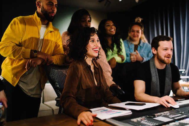 Raye helps students at the Brit School mix one of their songs (Mastercard/PA)