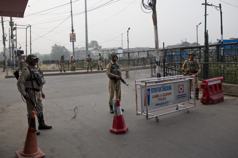 Indian paramilitary force soldiers stands guard near a temporary barricade during restrictions in Srinagar Indian controlled Kashmir, Friday, Sept. 27, 2019. Residents in Indian-controlled Kashmir waited anxiously as Indian and Pakistani leaders were scheduled to speak at the U.N. General Assembly later Friday. (AP Photo/ Dar Yasin)