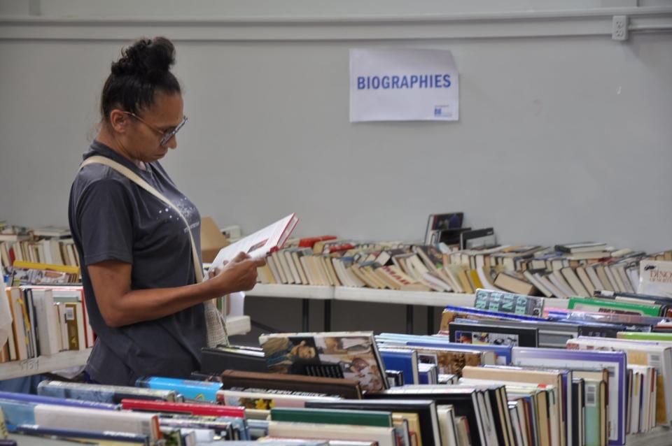 Jessica Herring of Alliance shops at the 2023 Friends of Rodman Public Library Used Book Sale on Saturday, Aug. 5, 2023. The popular sale draws people from across the country.