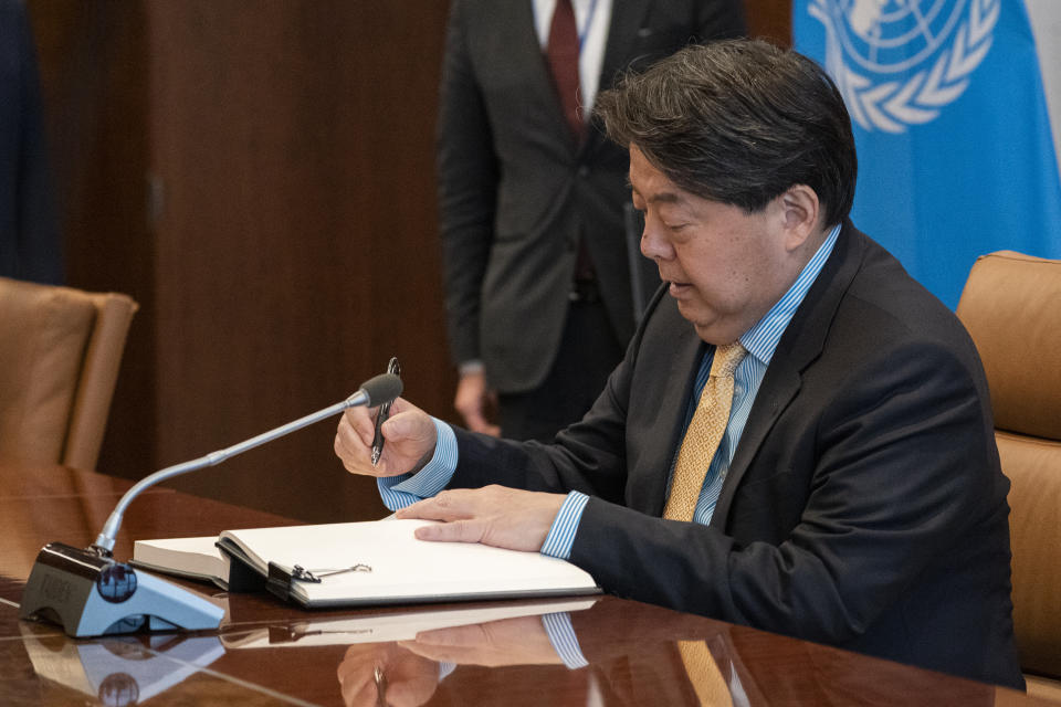 Hayashi Yoshimasa, Minister for Foreign Affairs of Japan, signs a guest book as he meets with United Nations Secretary General Antonio Guterres at United Nations headquarters, Thursday, Jan. 12, 2023. (AP Photo/John Minchillo)