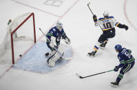 Vancouver Canucks goalie Jacob Markstrom (25) gives up a goal to St. Louis Blues' Brayden Schenn (10) as Troy Stecher (51) defends during overtime in Game 3 of an NHL hockey first-round playoff series, Sunday, Aug. 16, 2020, in Edmonton, Alberta. (Jason Franson/The Canadian Press via AP)