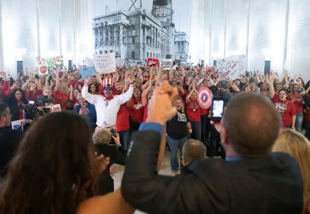 Striking teachers and legislators celebrate minutes after lawmakers reject a bill that would have opened the first charter schools in the state, at the Capitol building in Charleston, West Virginia, U.S., February 19, 2019. REUTERS/Lexi Browning